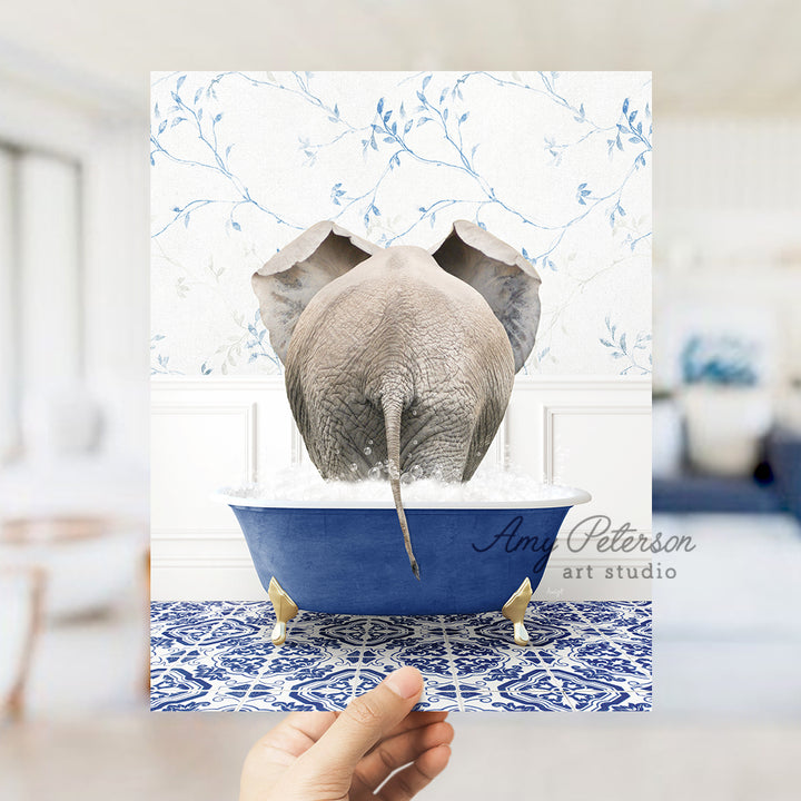 a person holding up a card with an elephant in a bathtub