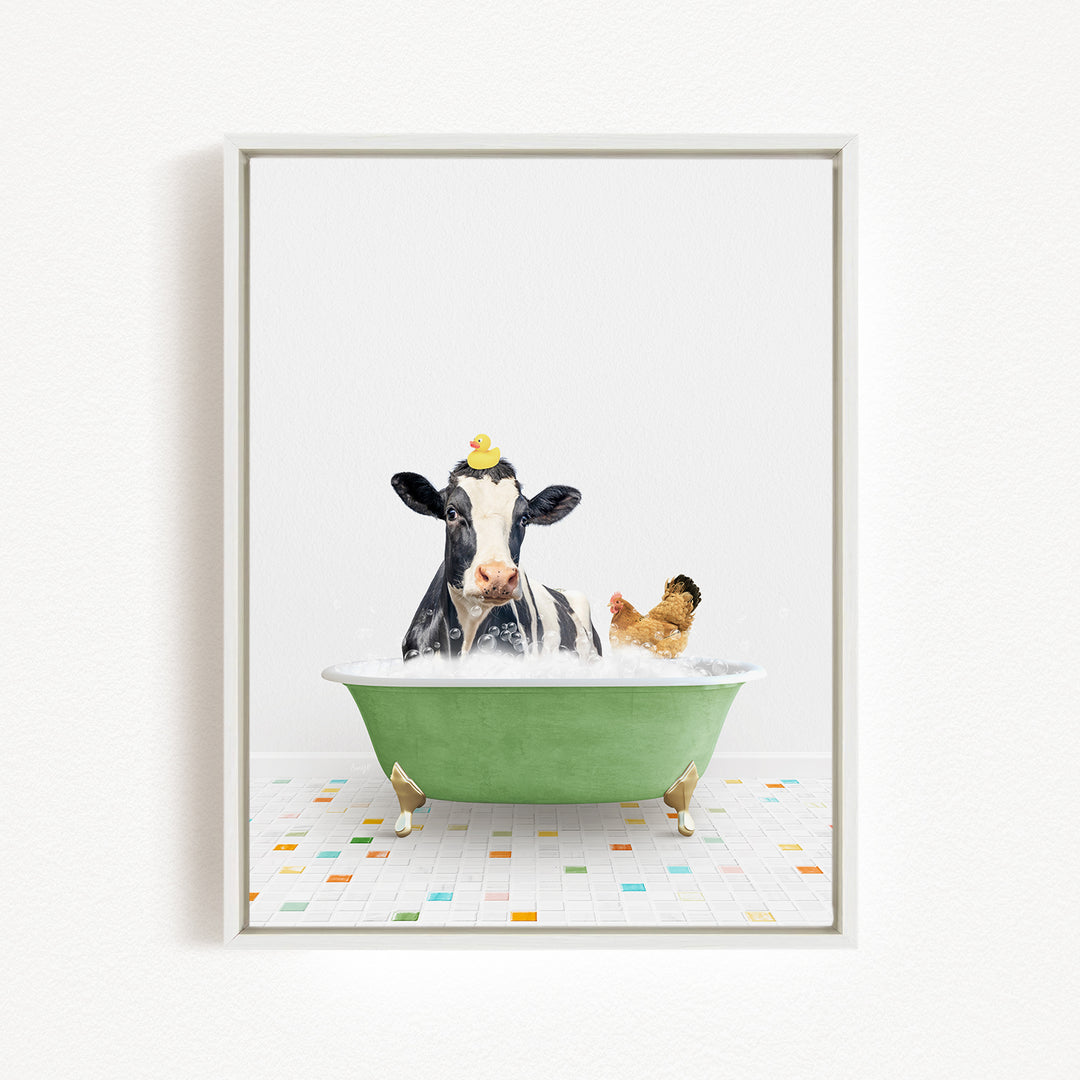 A black and white cow is sitting in a green bathtub filled with bubbles, with a yellow rubber duck perched on its head.