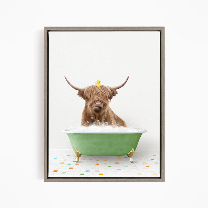 A Highland cow with large horns is sitting in a green bathtub filled with bubbles, with a yellow rubber duck perched on its head.