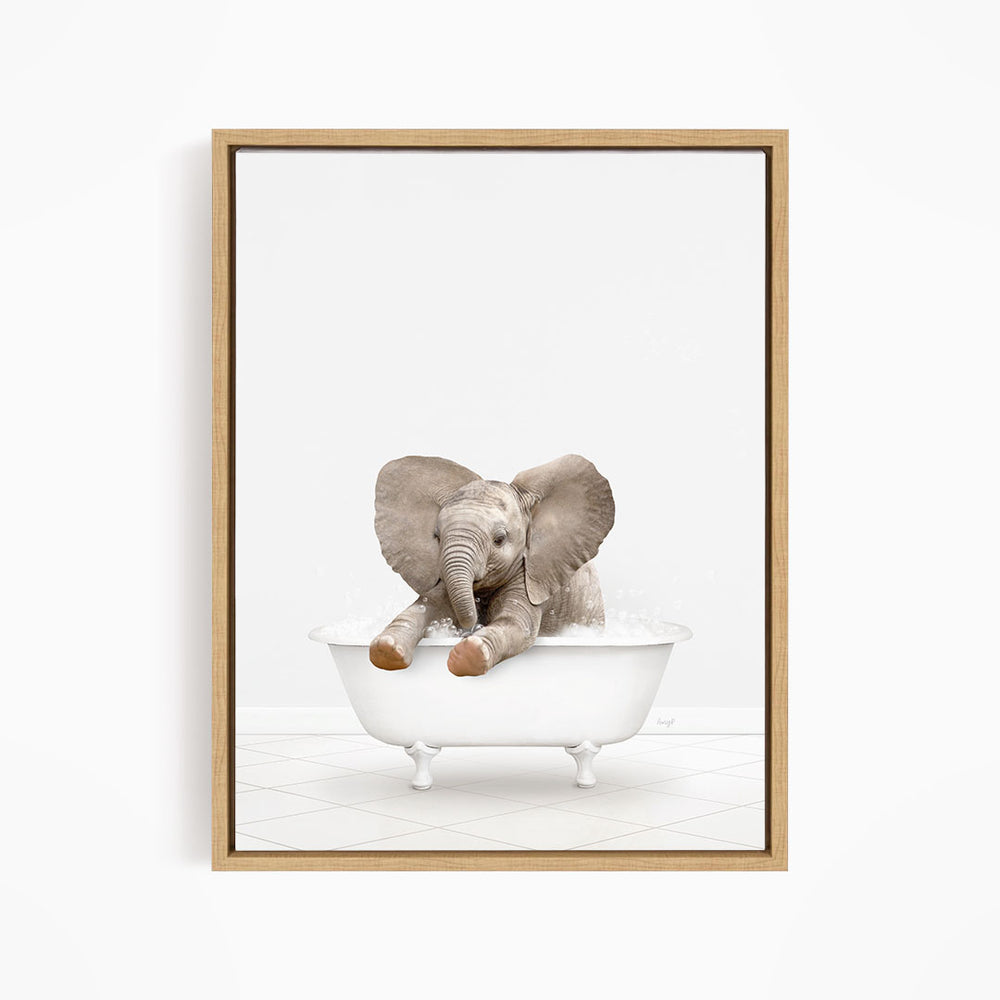 A baby elephant sitting in a white bathtub, with its trunk in the water.