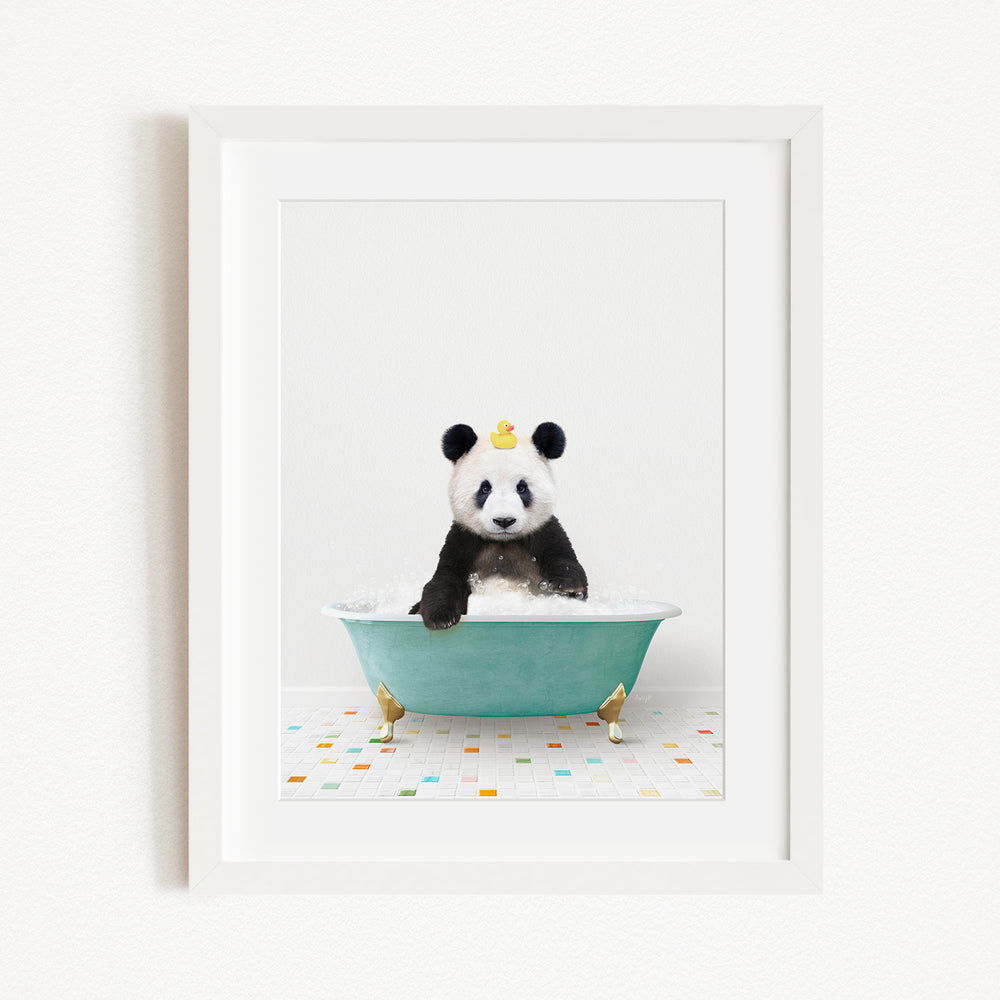 A panda bear sitting in a green bathtub, with a yellow rubber duck on its head.