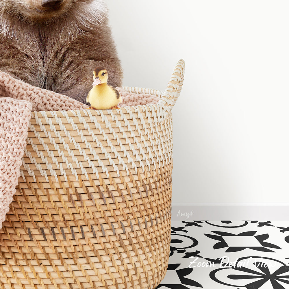 A small yellow duck sits in a woven basket, with a larger brown animal partially visible behind it.