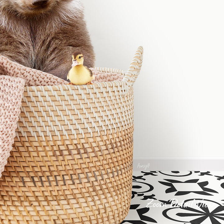 A small yellow duck sits in a woven basket, with a larger brown animal partially visible behind it.