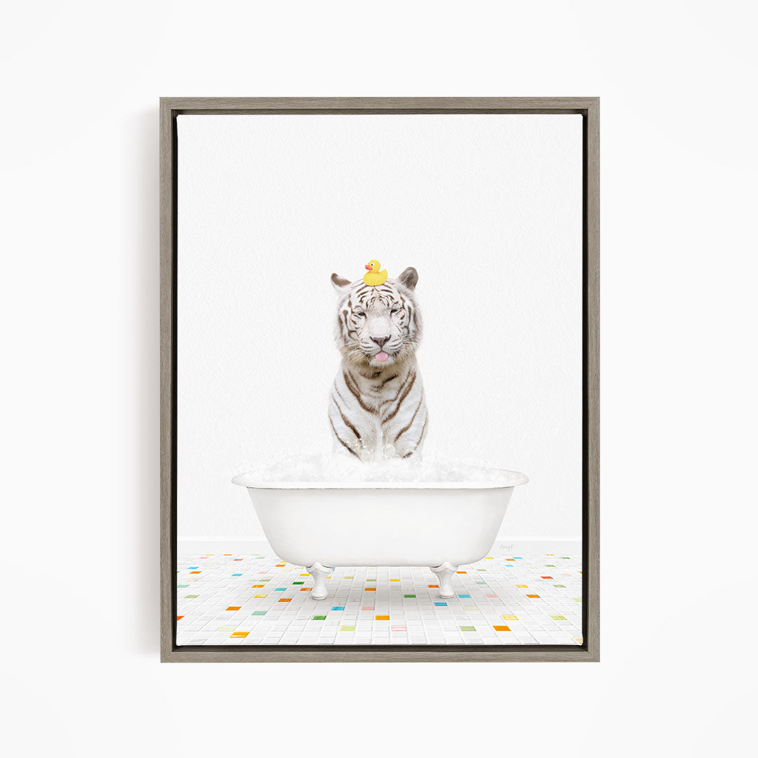 A white tiger is sitting in a white bathtub filled with water, with a yellow rubber duck perched on its head.