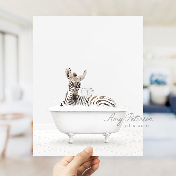 a person holding up a card with a zebra in a bathtub