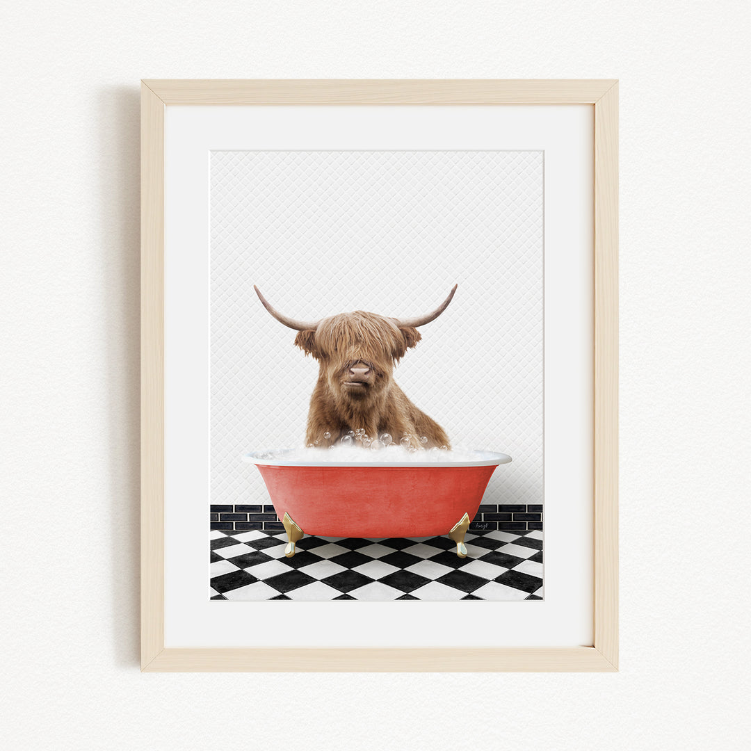 A brown cow with long horns is sitting in a red bathtub on a black and white checkered floor.