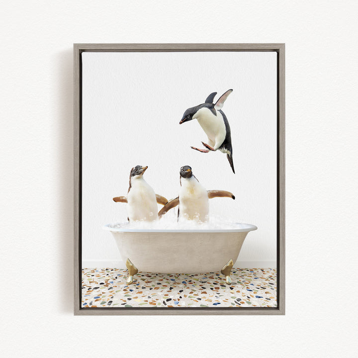 A framed image depicting three penguins in a bathtub, with one penguin flying out of the tub.