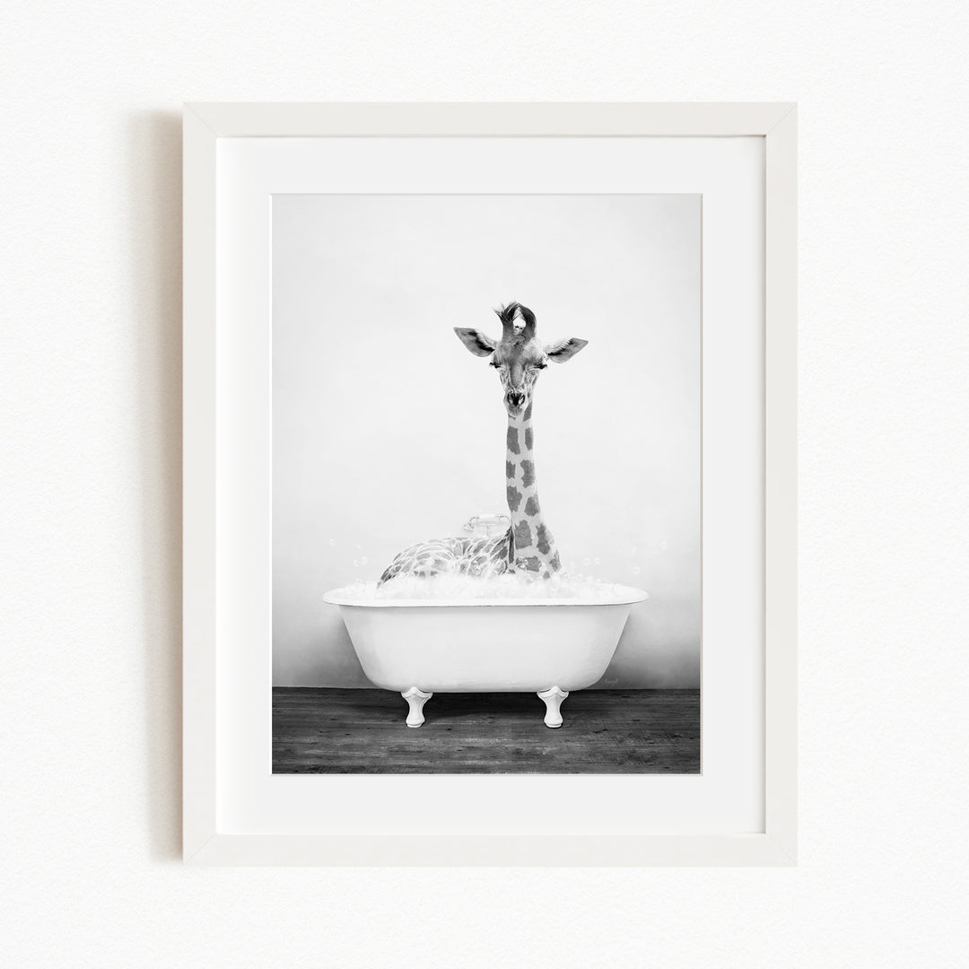 A giraffe standing in a white bathtub filled with water, creating a whimsical and playful scene.