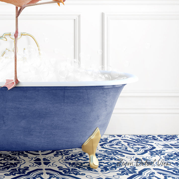 A blue claw-foot bathtub filled with water, with a gold shoe placed on the floor next to it.