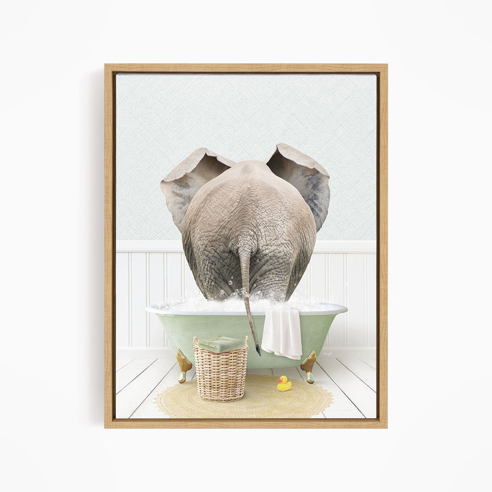 A large elephant is taking a bath in a green bathtub, surrounded by a basket of toys and rubber ducks.