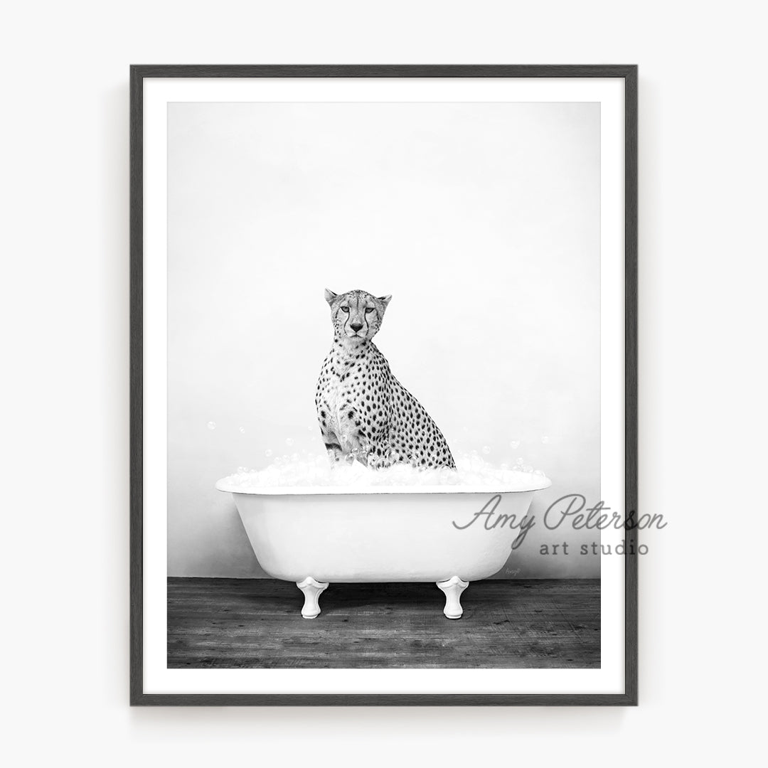 a black and white photo of a cheetah sitting in a bathtub