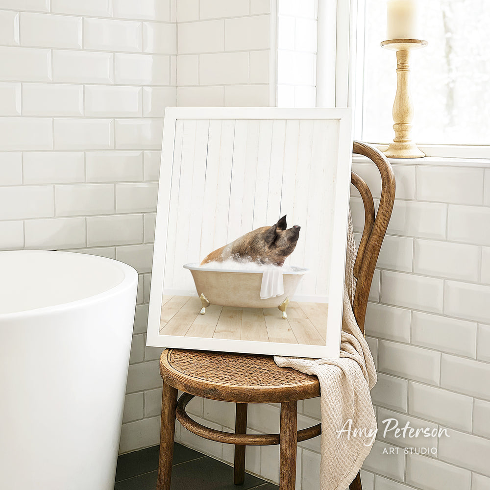A framed image of a pig sitting in a bathtub, surrounded by white tiles, is displayed on a wooden chair in a bathroom setting.