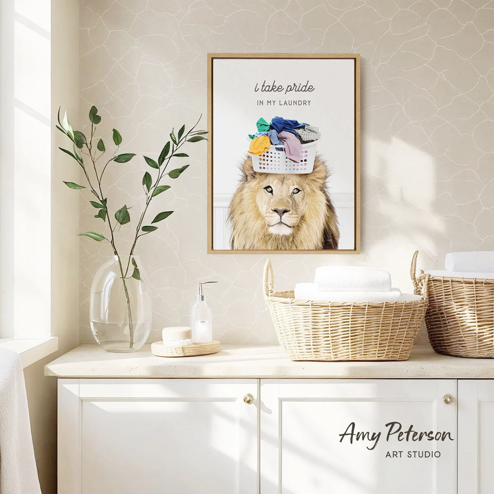 a framed poster of a lion wearing a laundry basket on its head, placed on a wall above a white cabinet with baskets.
