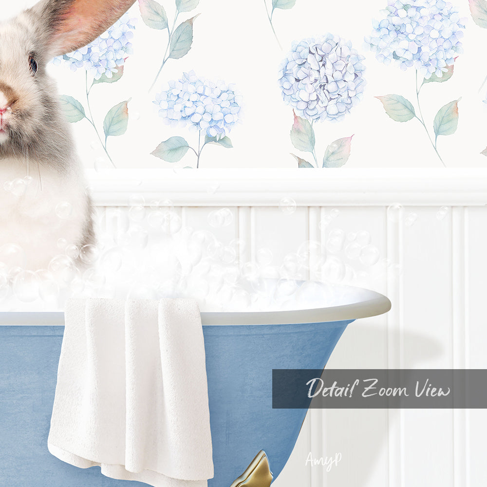 A white rabbit sitting in a blue bathtub filled with bubbles, with a floral wallpaper in the background.
