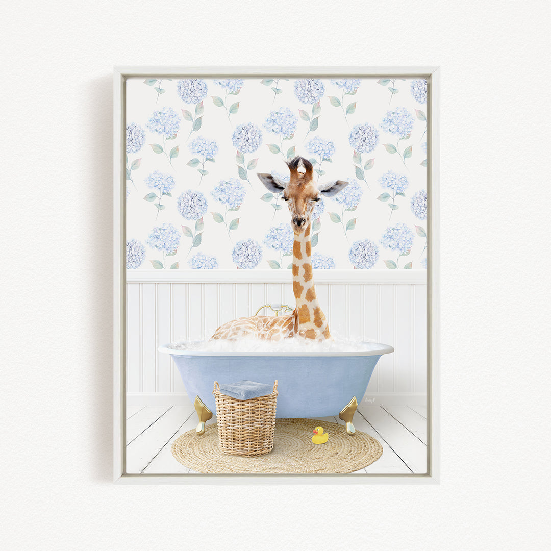 A giraffe is sitting in a blue bathtub filled with water, surrounded by a wicker basket and a yellow rubber duck.