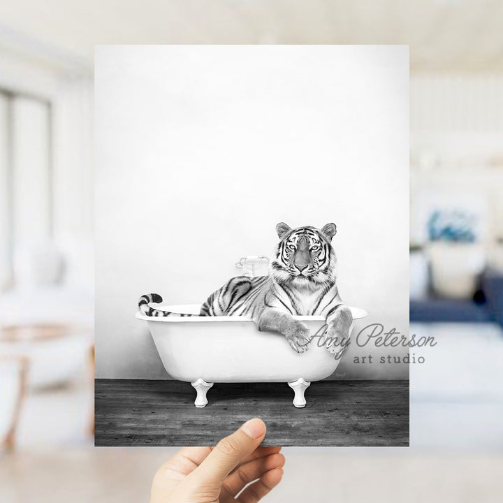 a black and white photo of a tiger in a bathtub