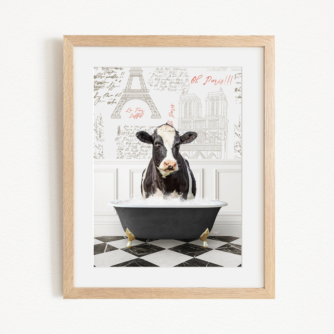 A black and white cow is sitting in a bathtub filled with water, surrounded by a Paris-themed background with the Eiffel Tower and other landmarks.