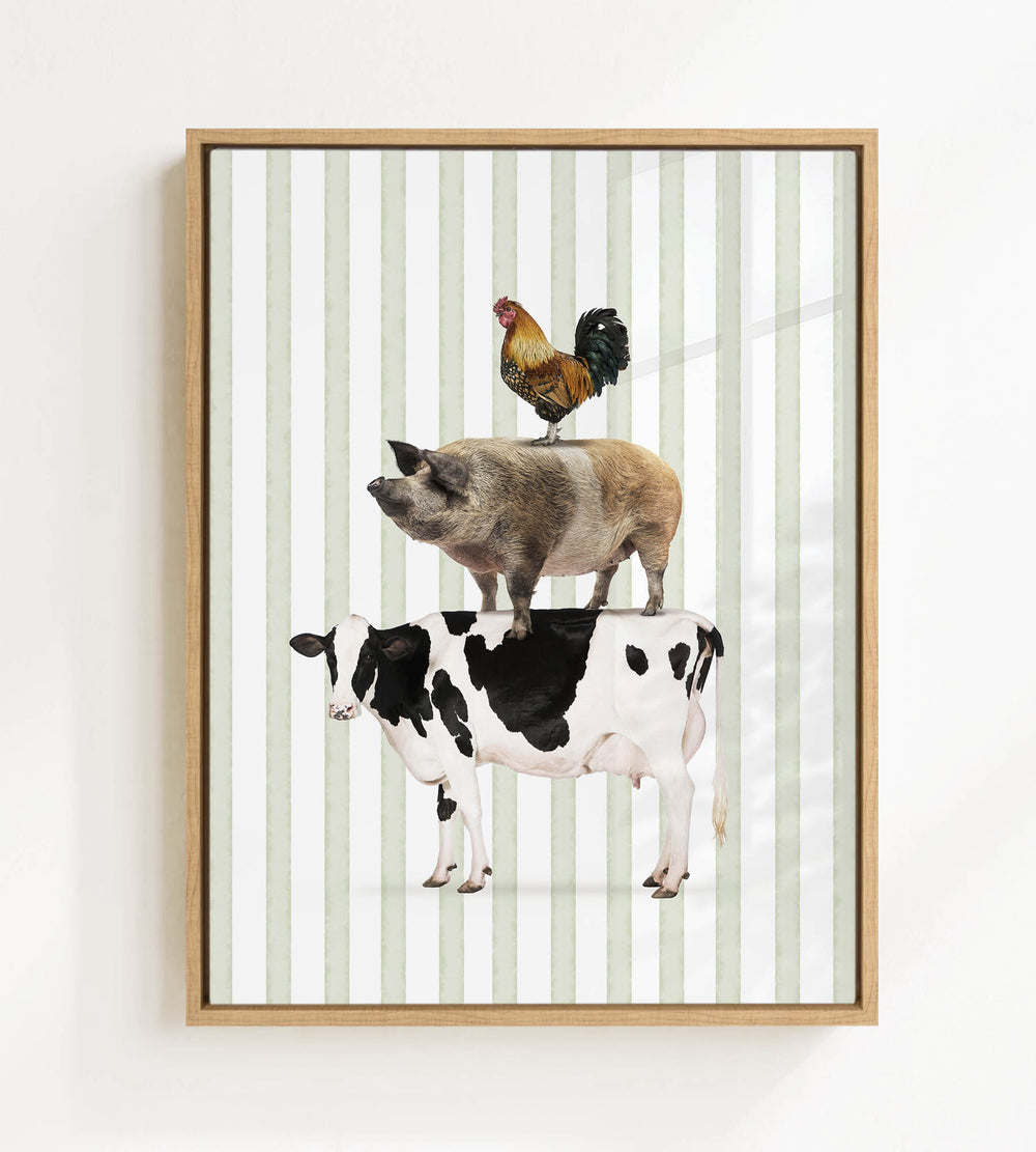 A framed image depicting a cow, pig, and rooster standing on top of each other.