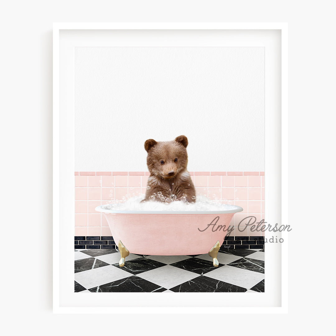 a brown teddy bear sitting in a pink bath tub