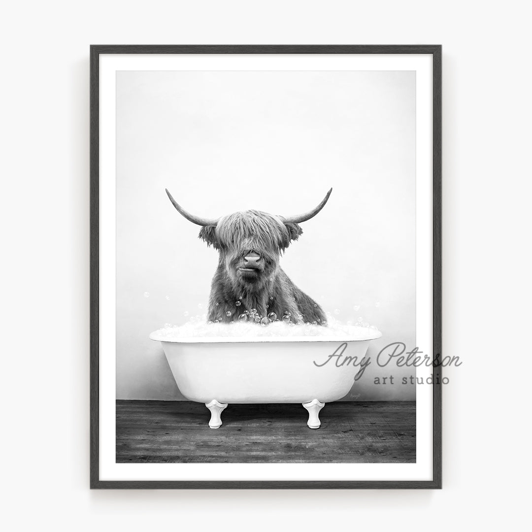 a black and white photo of a bull in a bathtub