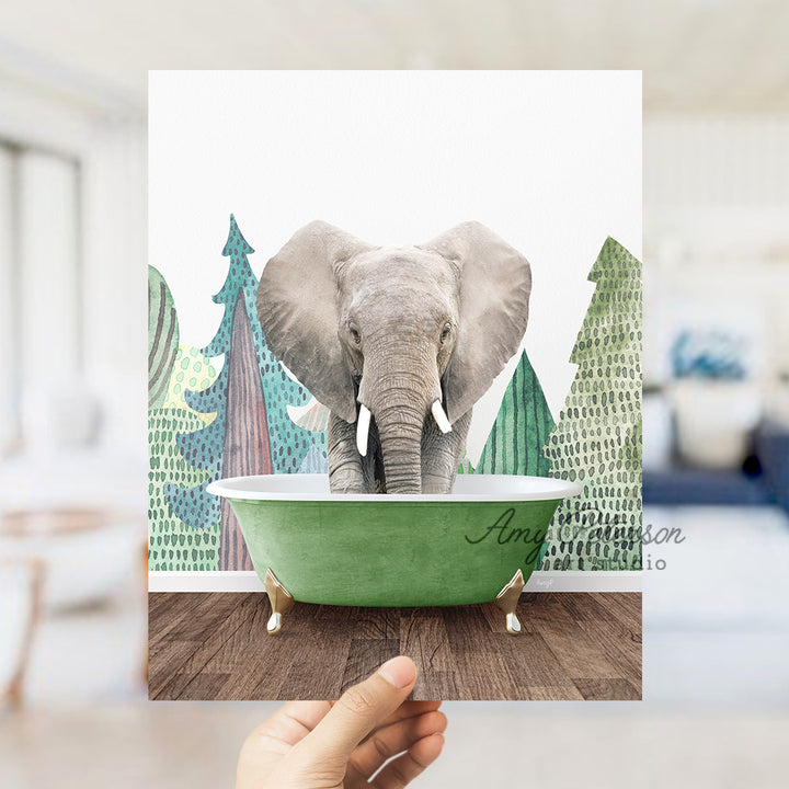 a person holding up a picture of an elephant in a bathtub