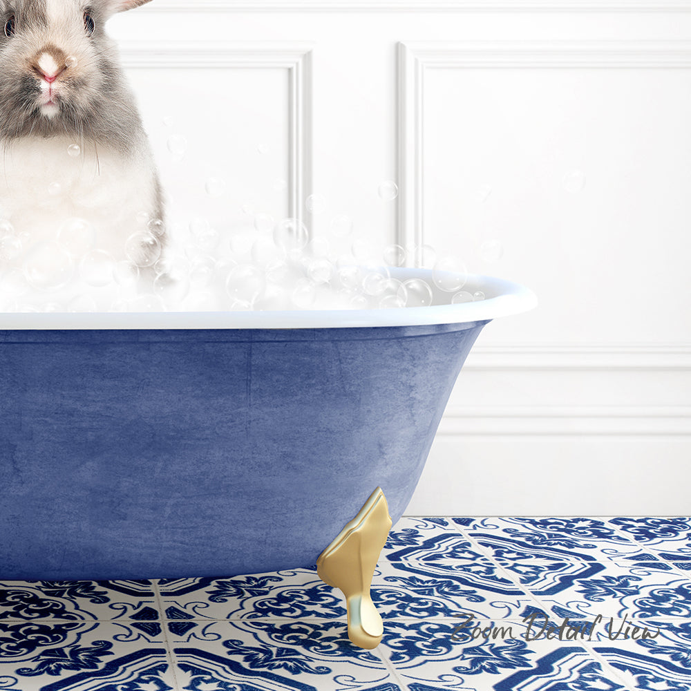 A white rabbit sitting in a blue bathtub filled with bubbles, with a patterned tile floor in the background.