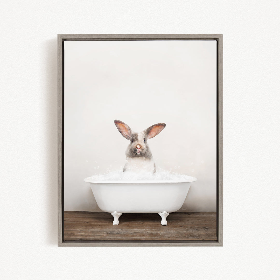 A white rabbit sitting in a white bathtub filled with water, looking directly at the camera.