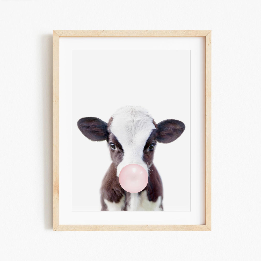 a picture of a cow with a bubble in its mouth