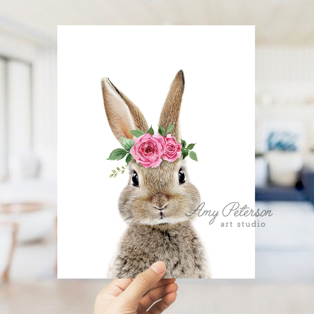 a person holding up a card with a picture of a rabbit wearing a flower crown