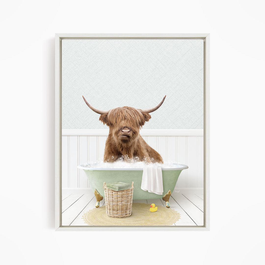A brown cow with long horns is sitting in a green bathtub filled with water, surrounded by a yellow rubber duck and a basket.