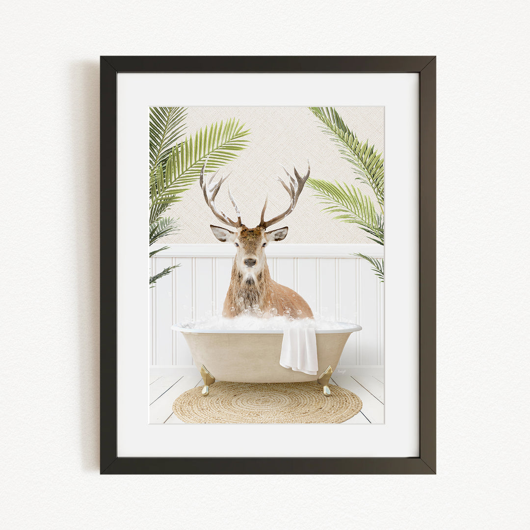 A deer with antlers is sitting in a bathtub filled with water, surrounded by green plants.