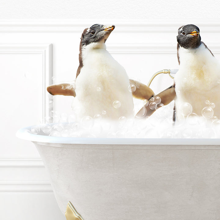 two penguins sitting in a bathtub with bubbles