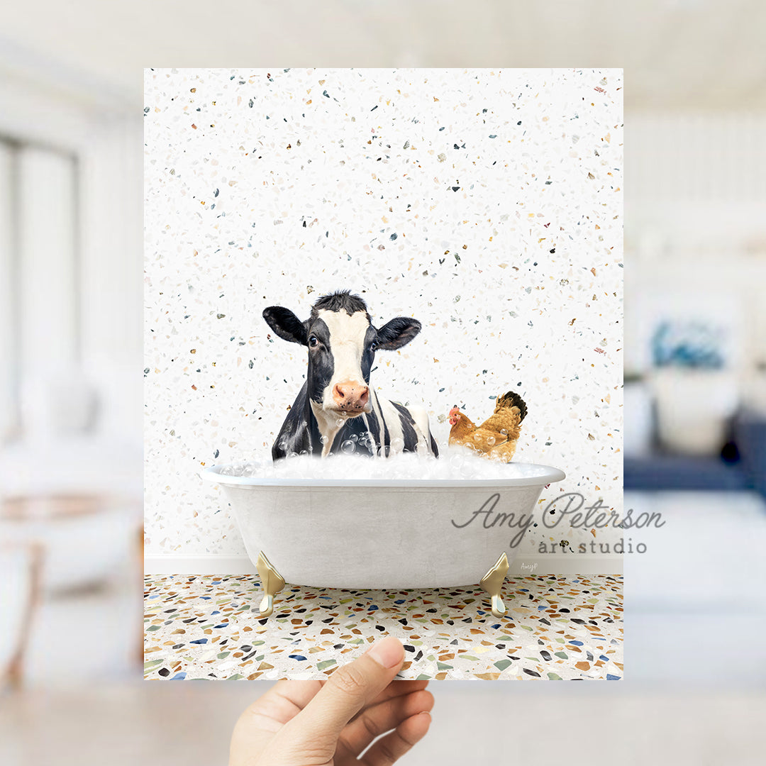 a hand holding up a card with a picture of a cow in a bathtub