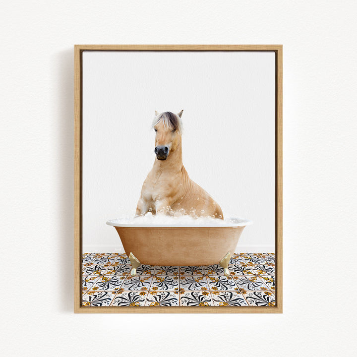 A light brown horse is sitting in a bathtub filled with bubbles, surrounded by a patterned tile floor.
