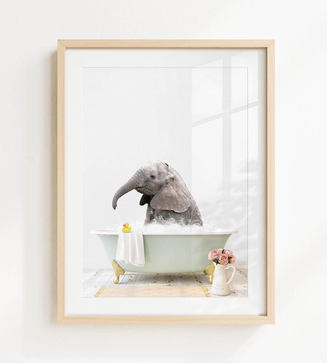 A gray elephant is sitting in a green bathtub filled with bubbles, surrounded by a yellow rubber duck and pink flowers.