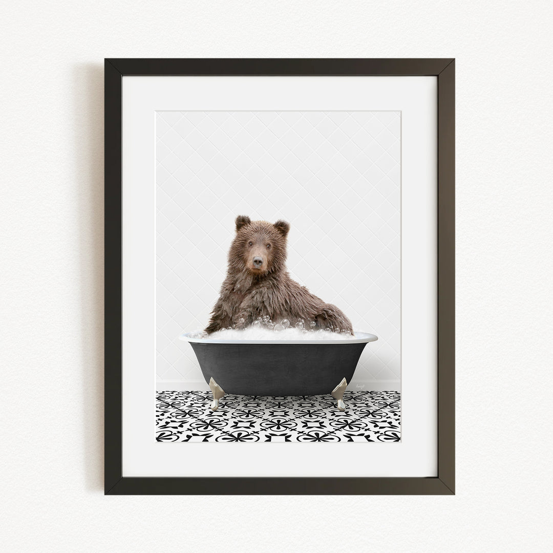 A brown bear sitting in a black bathtub filled with water, surrounded by a black and white patterned floor.
