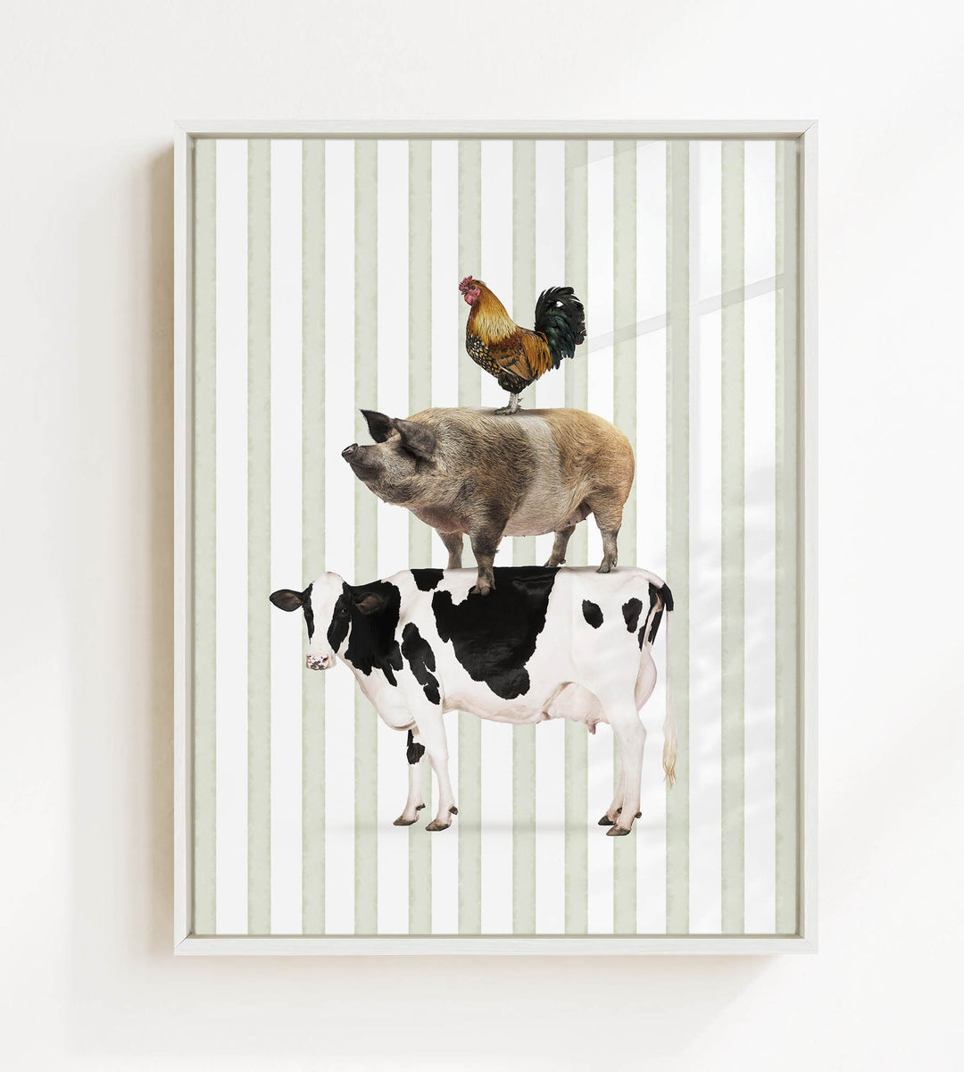 A framed image depicting a cow, pig, and rooster standing on top of each other.