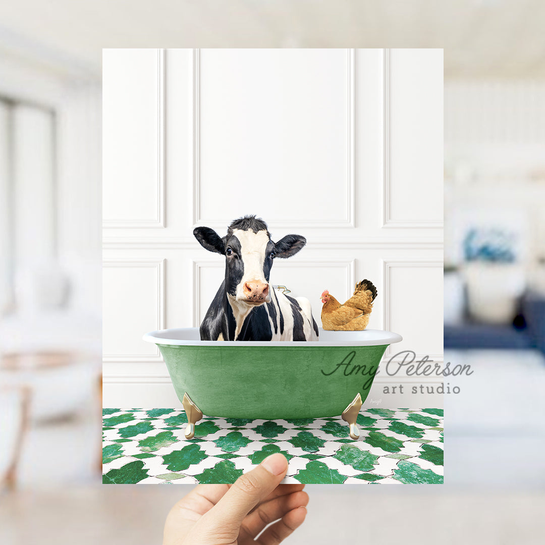 a hand holding a card with a picture of a cow in a bathtub