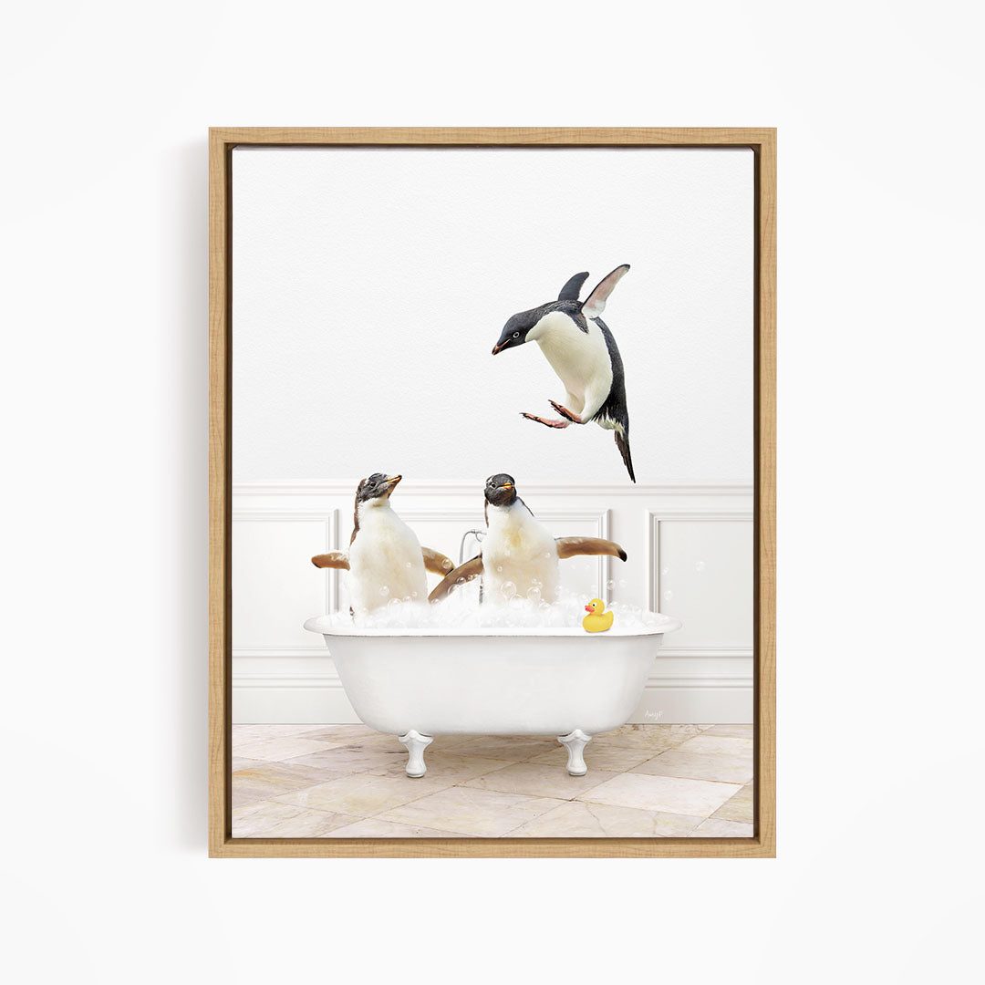 A framed image depicting three penguins sitting in a bathtub, with one penguin flying towards the others.