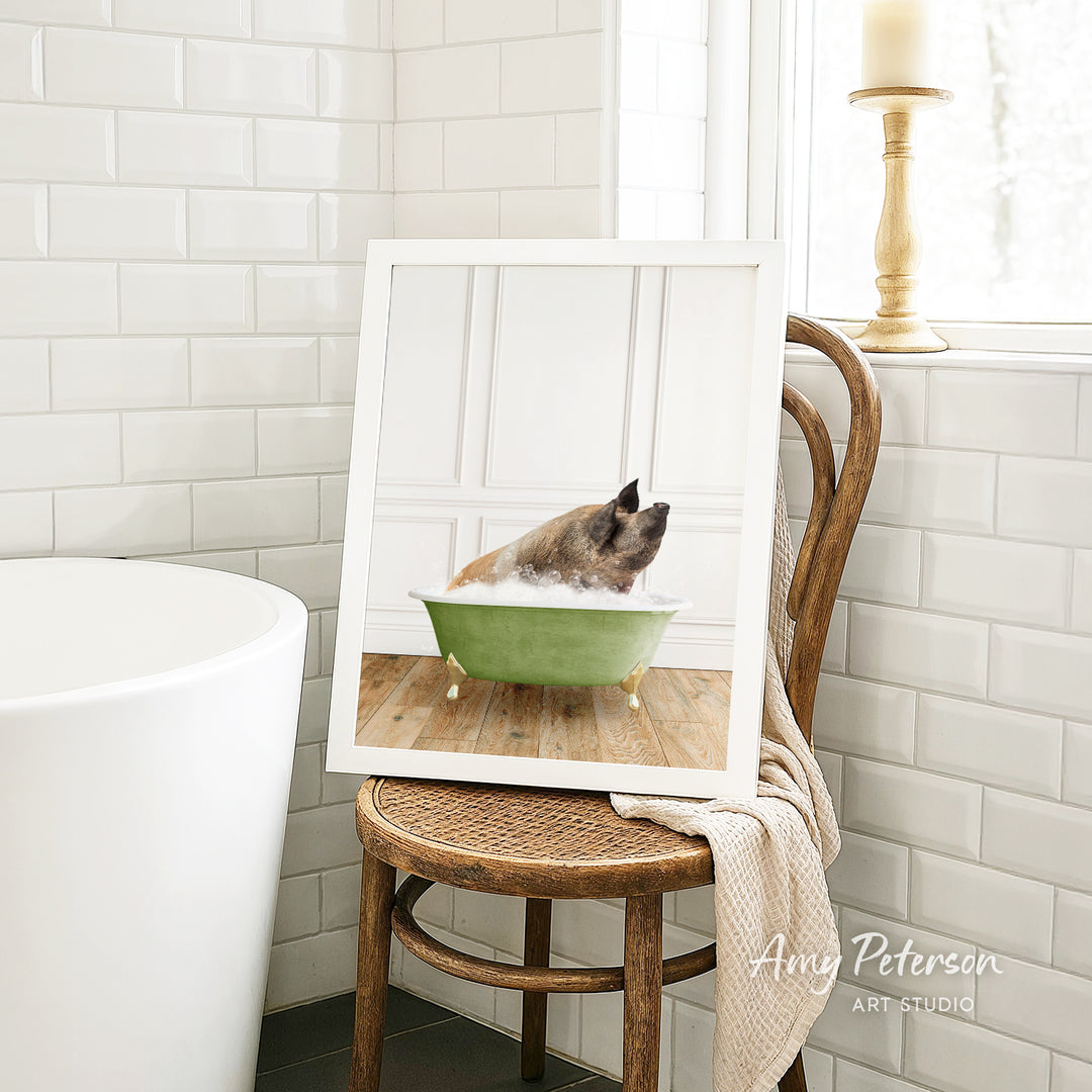 A framed image of a dog sitting in a green bathtub, with a towel draped over the back of the chair.