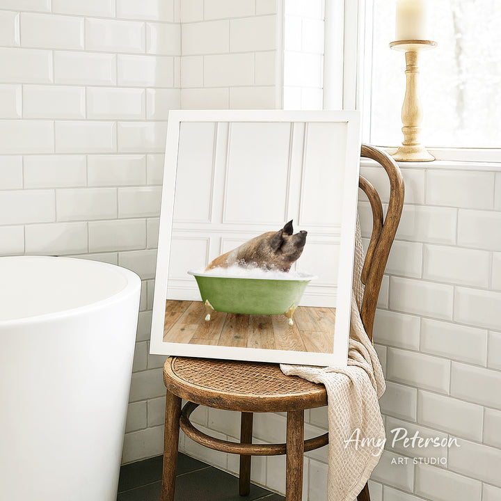 A framed image of a dog sitting in a green bathtub, with a towel draped over the back of the chair.