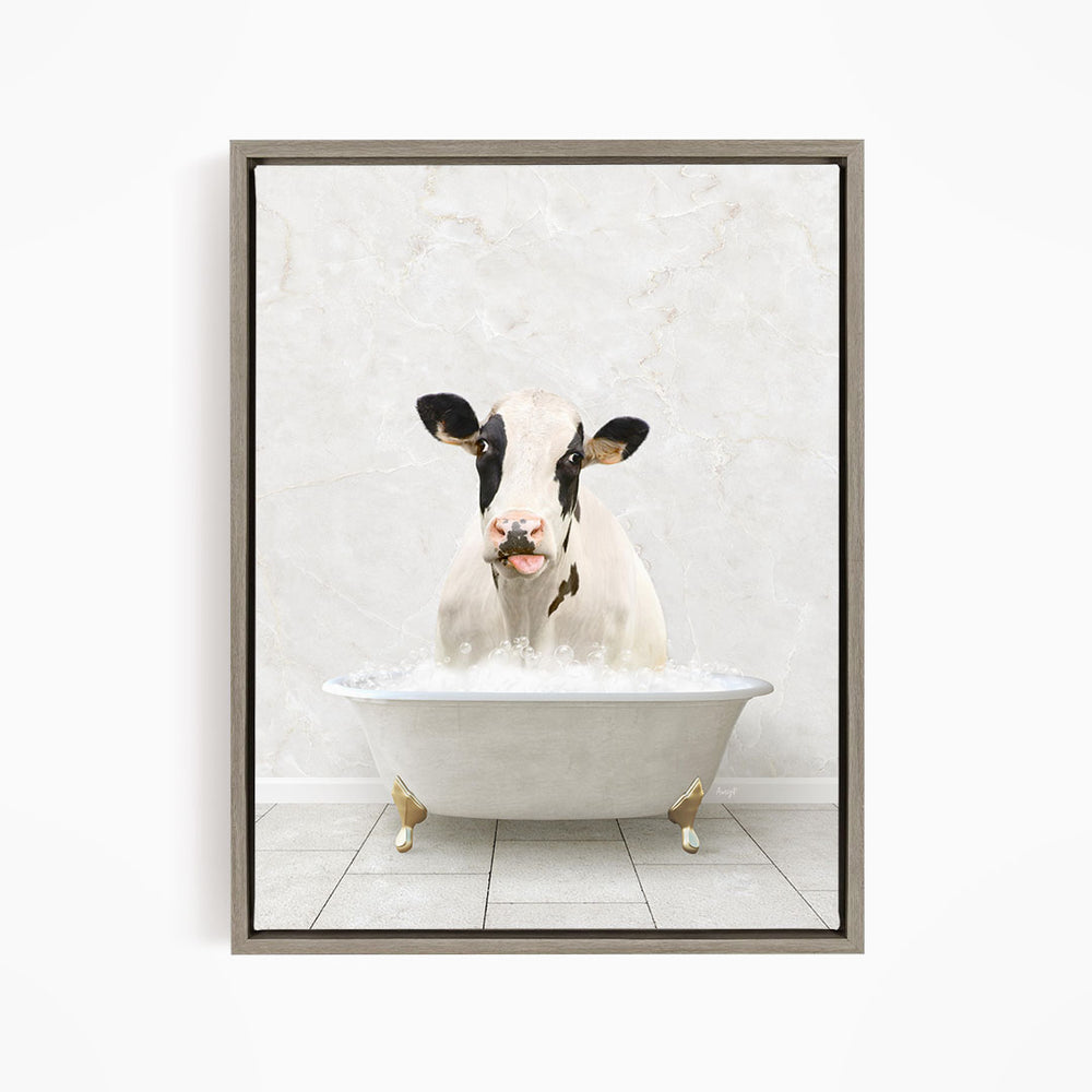 A black and white cow is sitting in a white bathtub filled with water, creating a whimsical and humorous scene.