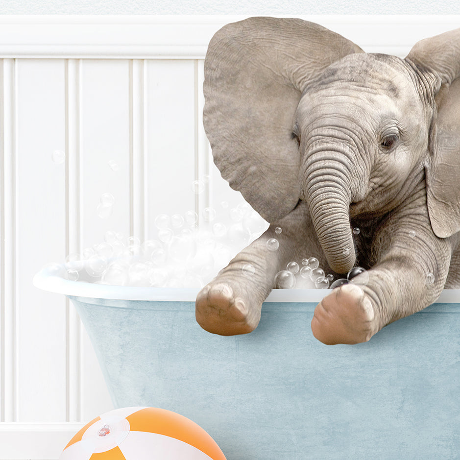 a baby elephant taking a bath in a bathtub