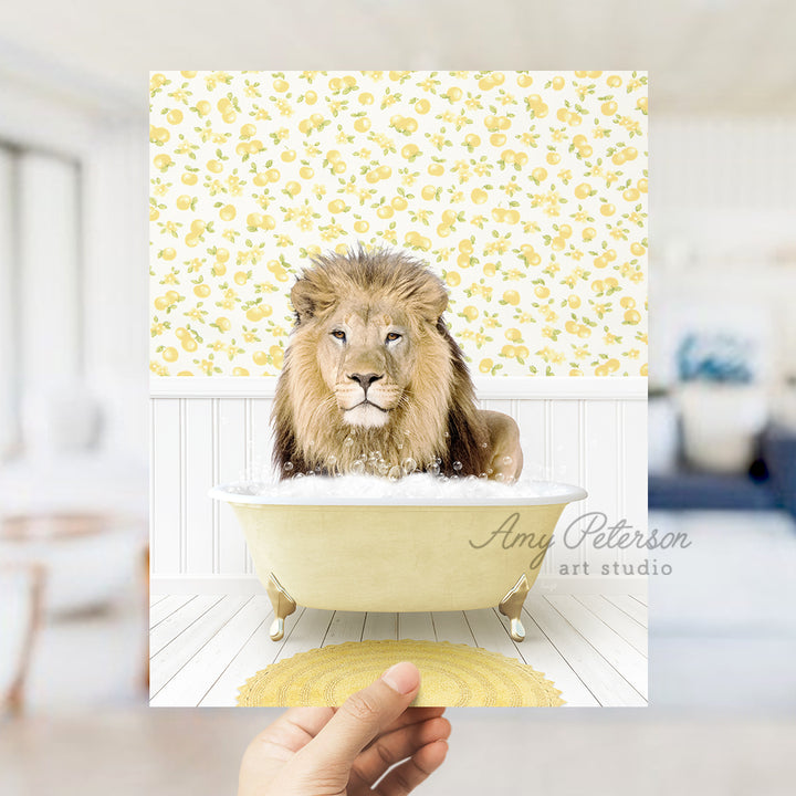 a lion sitting in a bathtub with a hand holding it