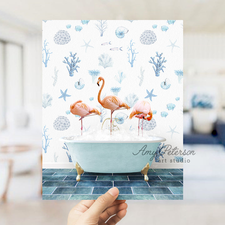 a person holding up a card with flamingos in a bathtub