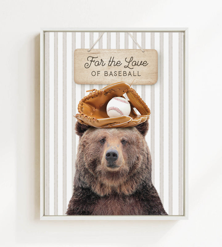 A brown bear wearing a baseball glove and ball sits in front of a wooden sign that says "For the Love of Baseball".
