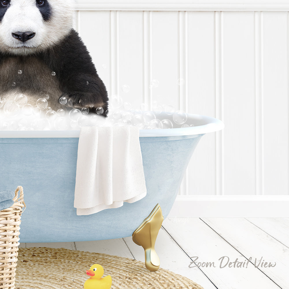 A panda bear sitting in a blue bathtub filled with bubbles, surrounded by a yellow rubber duck and a white towel.