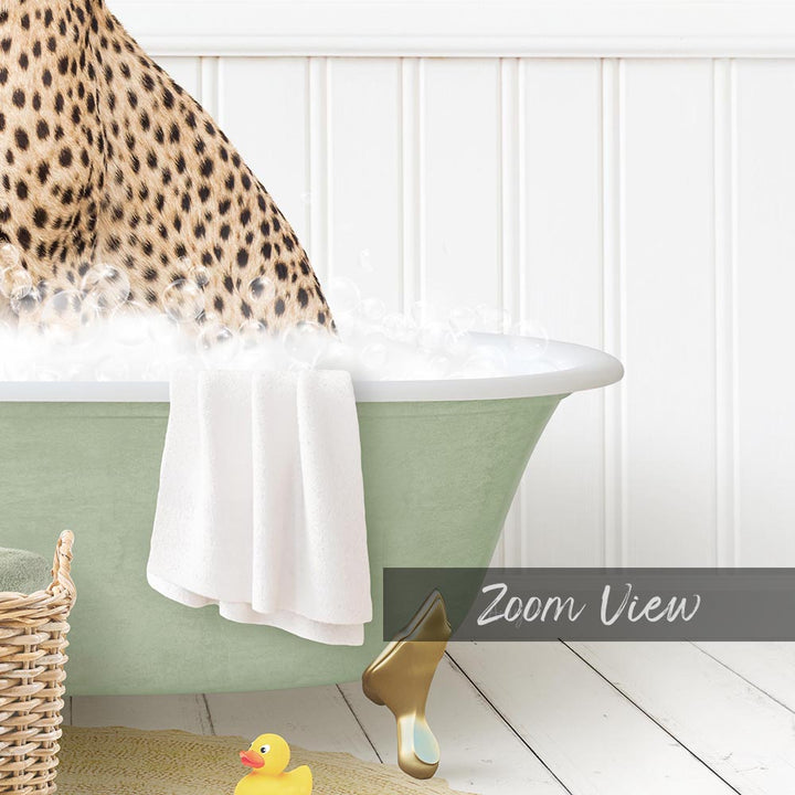 A leopard-print cat is sitting in a green bathtub filled with water, with a rubber duck nearby and a towel draped over the side.