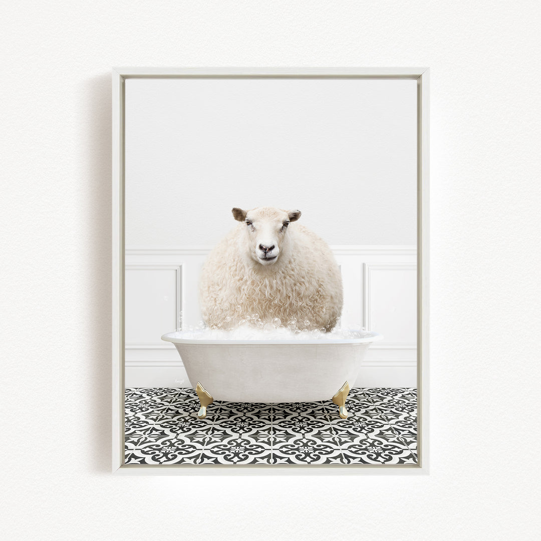 A fluffy white sheep sits in a white bathtub filled with bubbles, surrounded by a black and white patterned floor.
