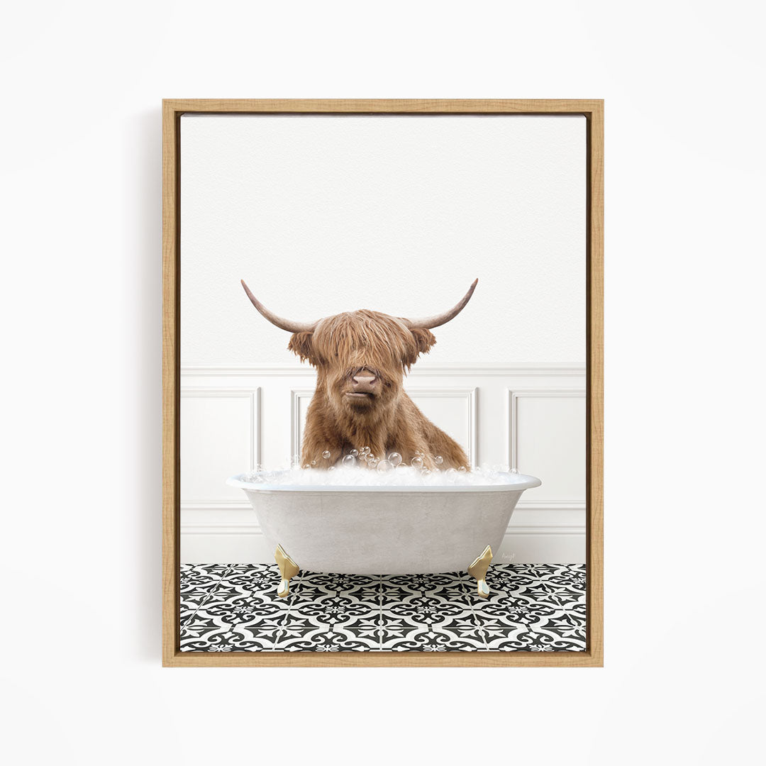 A brown cow with long horns is sitting in a white bathtub filled with water, creating a whimsical and amusing scene.